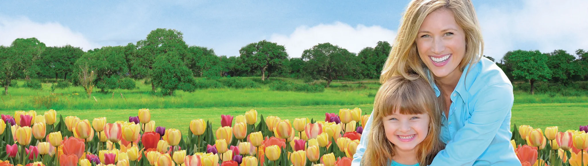Mother and daughter in a field of flowers.